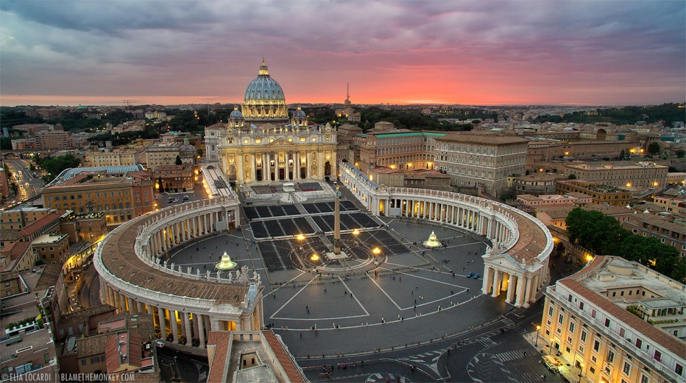 A spectacular view from above, as the sky lights up behind The Vatican in Rome.